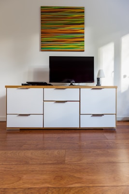 black flat screen tv on white wooden cabinet