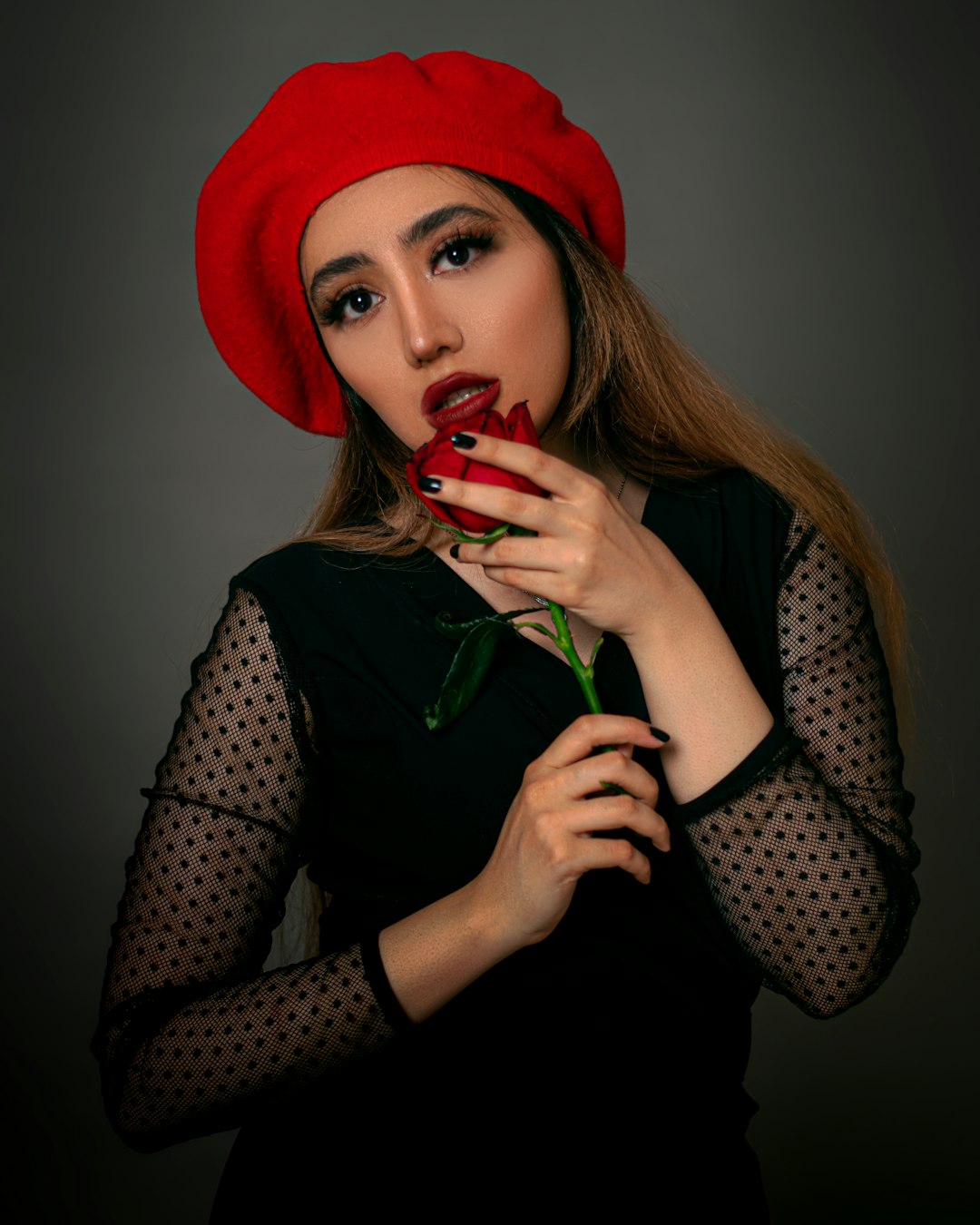 woman in black and white polka dot long sleeve shirt wearing red hat