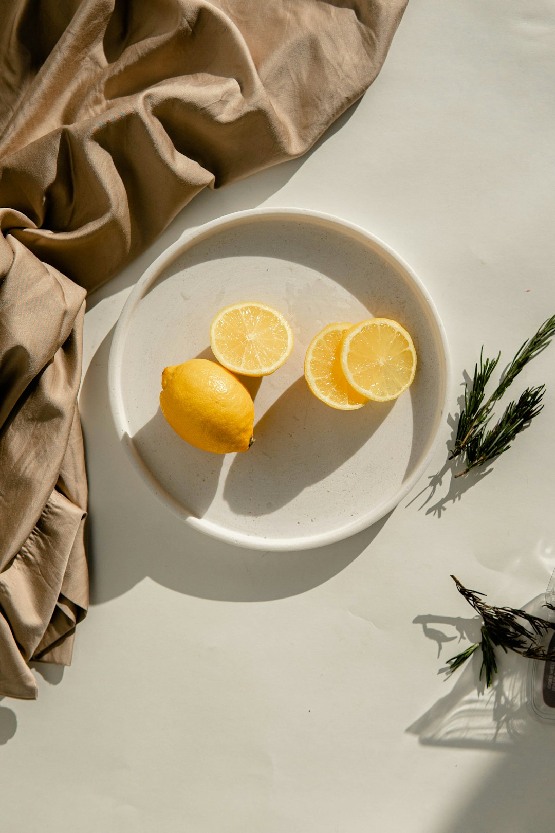 sliced lemon on white ceramic plate