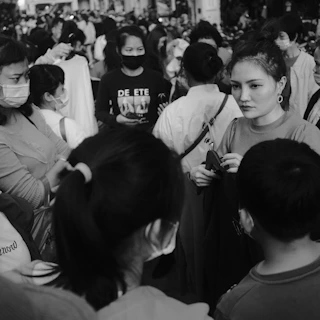 Community members chatting and selecting clothing items during a busy distribution day