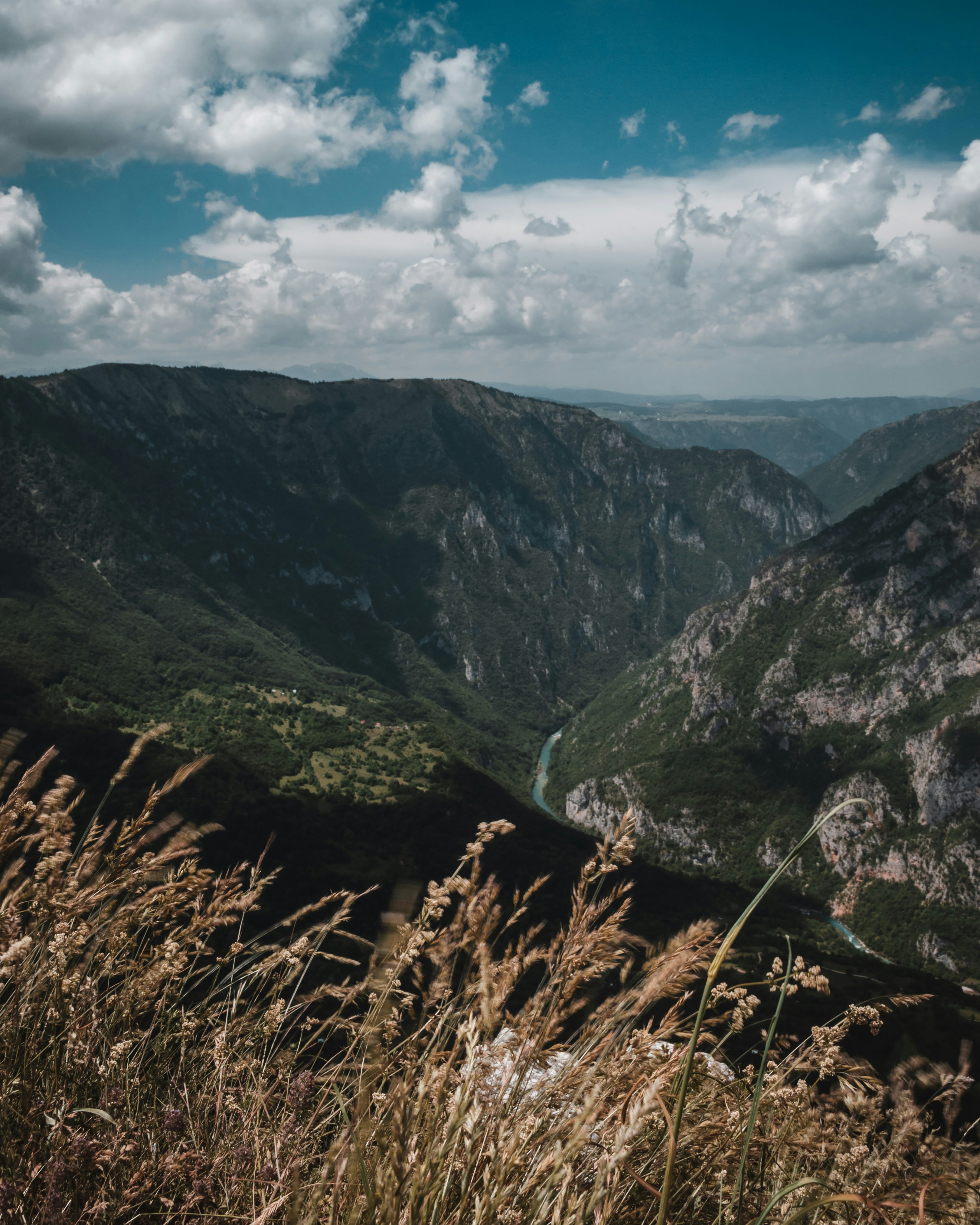 green and brown mountains under blue sky and white clouds during daytime