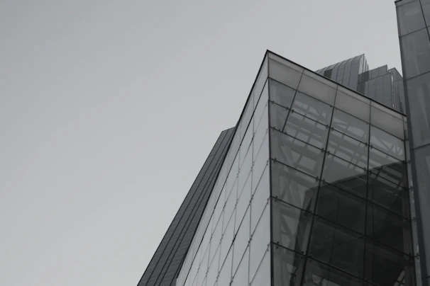 A sleek, modern building under construction with sharp lines and a charcoal and gold color scheme.