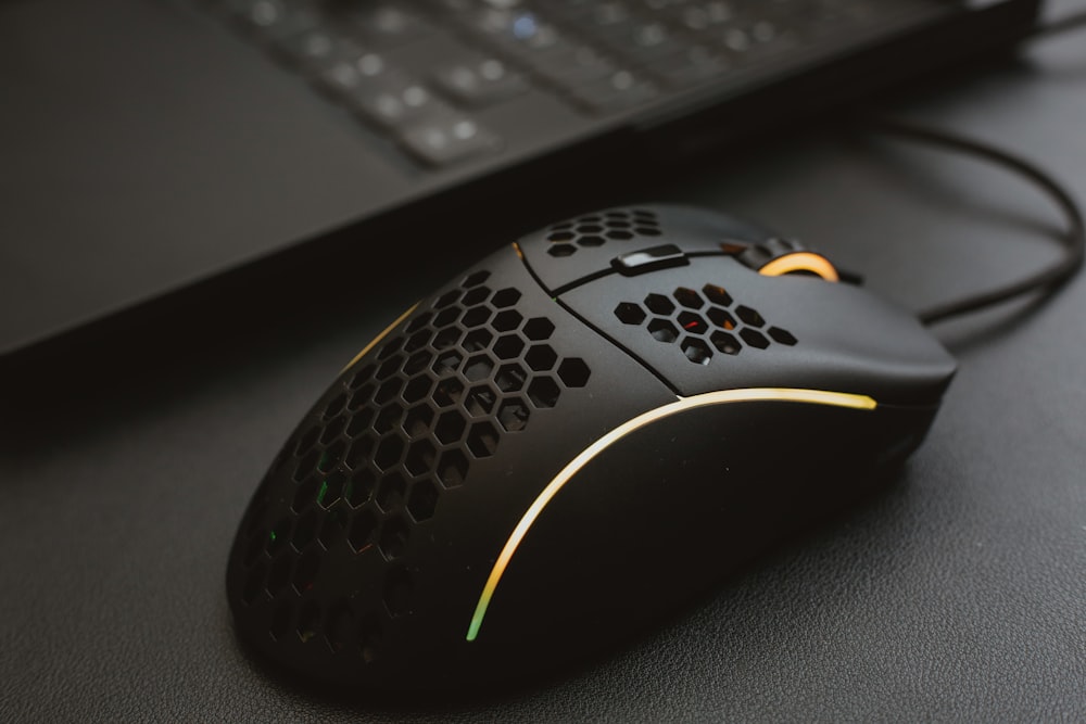 black and yellow logitech computer mouse