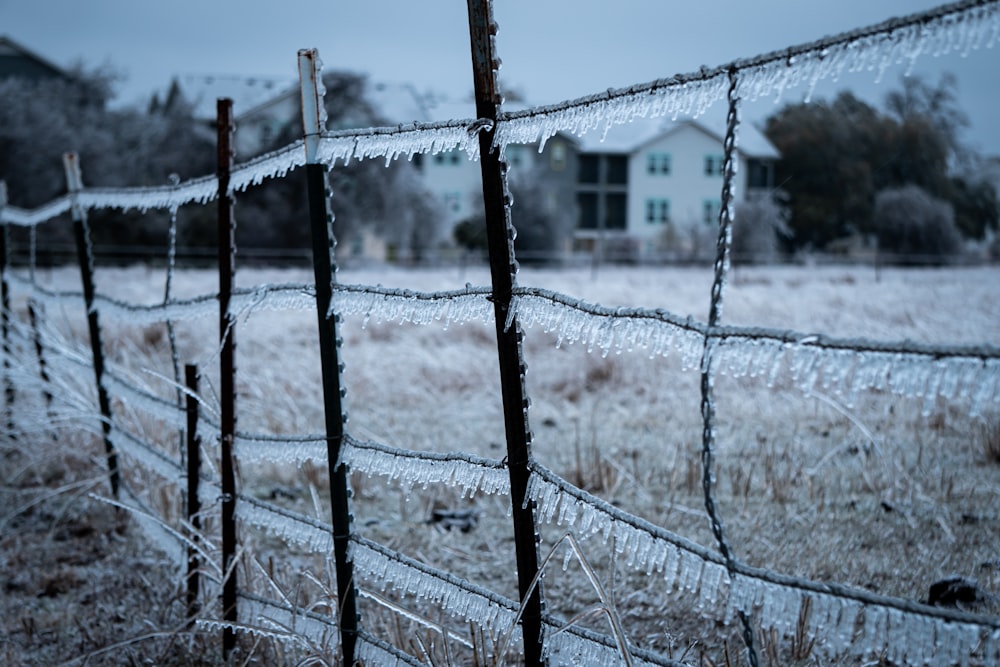 grey metal fence with snow on the ground