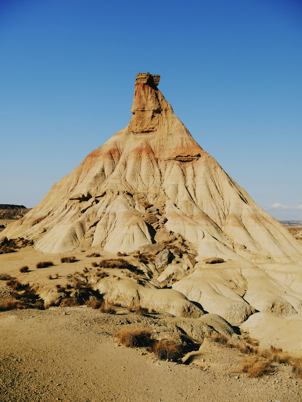 a very tall mountain in the middle of a desert