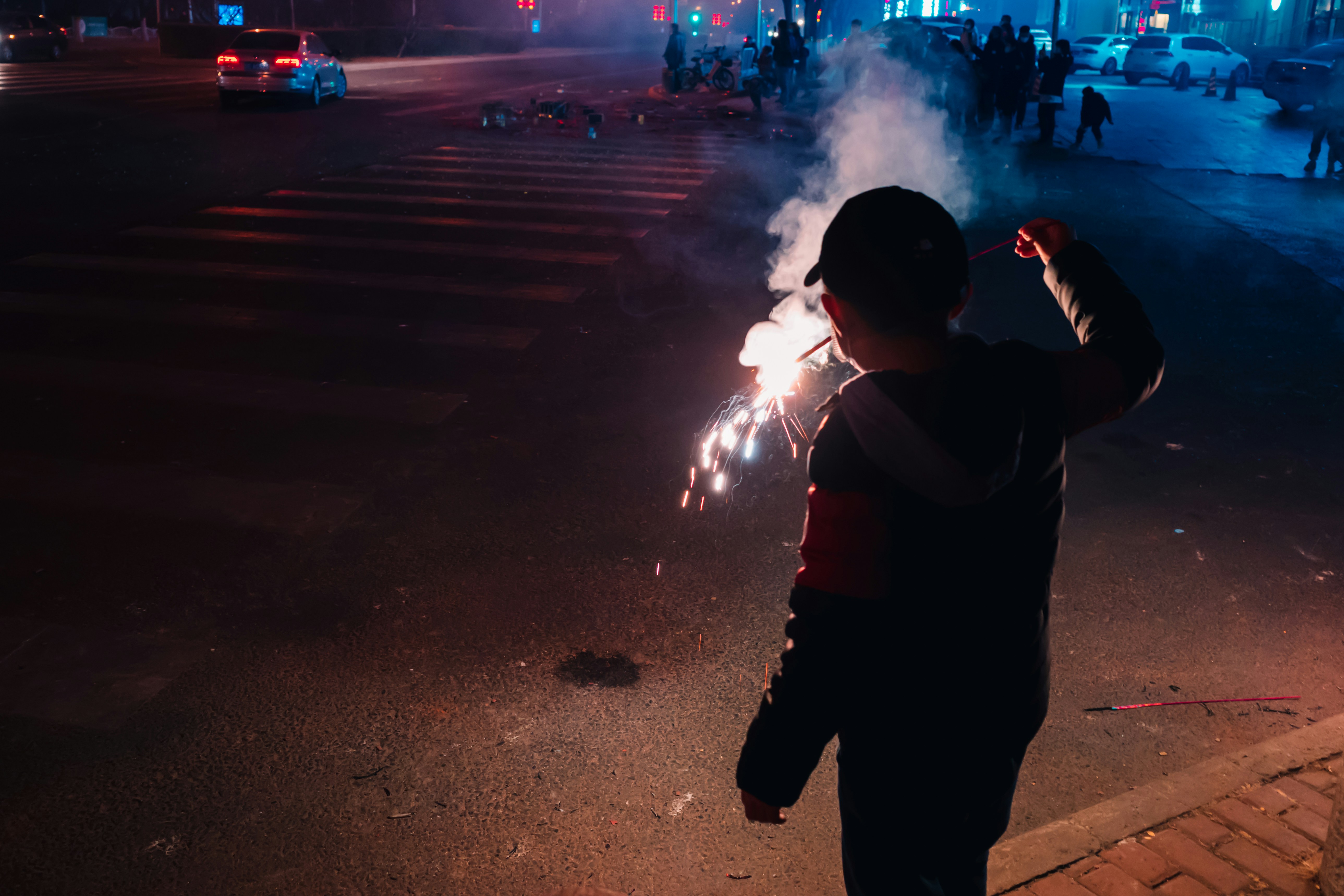 man in black shirt and pants holding a light