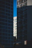 Modern cityscape with geometric shapes and contrasting light and shadow.