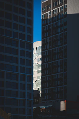 Modern cityscape with geometric shapes and contrasting light and shadow.