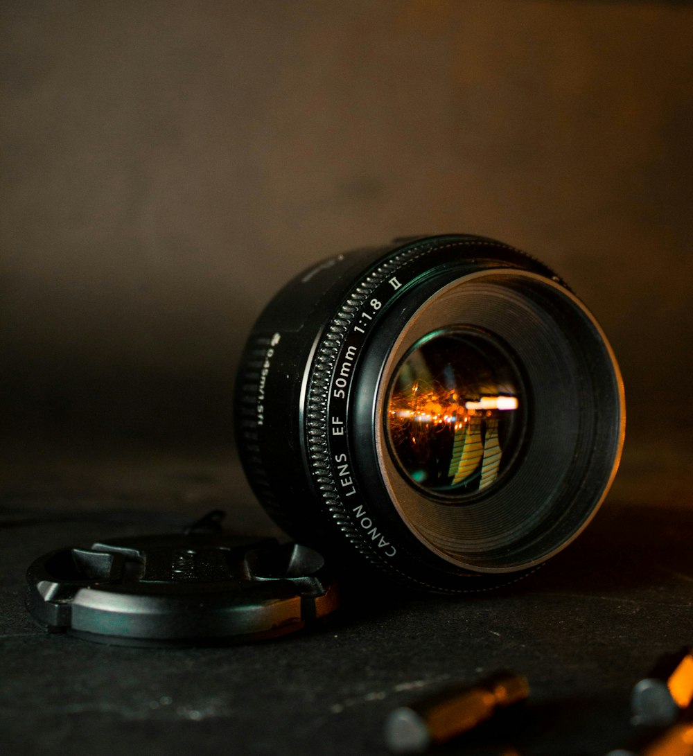 black camera lens on brown wooden table