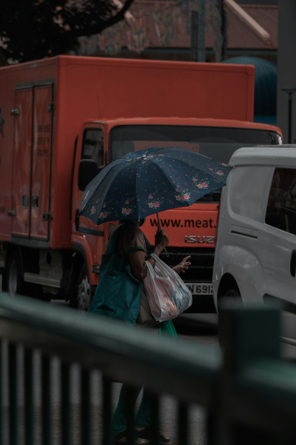 woman in blue denim jacket holding umbrella