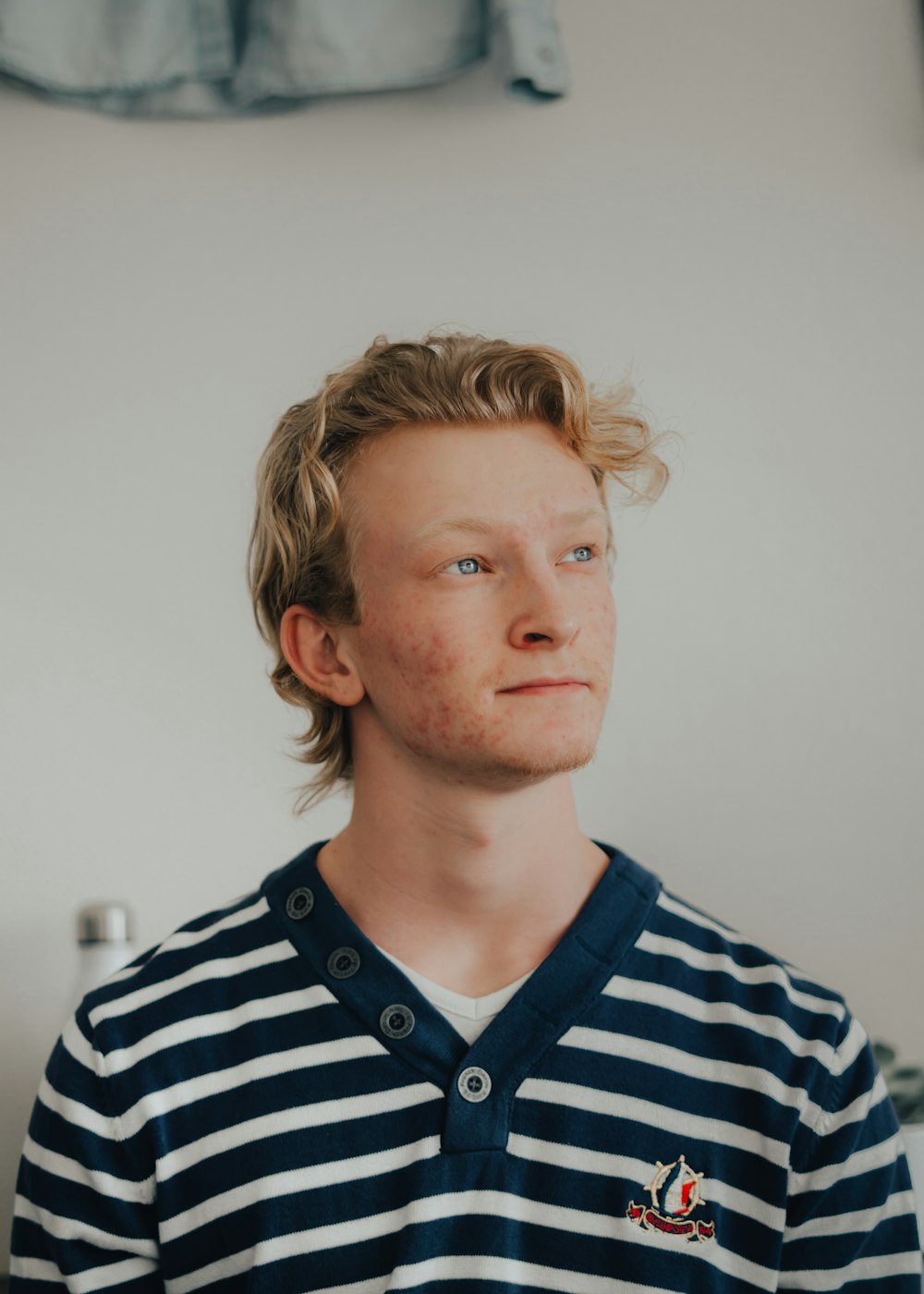 man in blue and white striped polo shirt