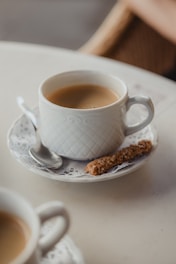 white ceramic mug on white ceramic saucer