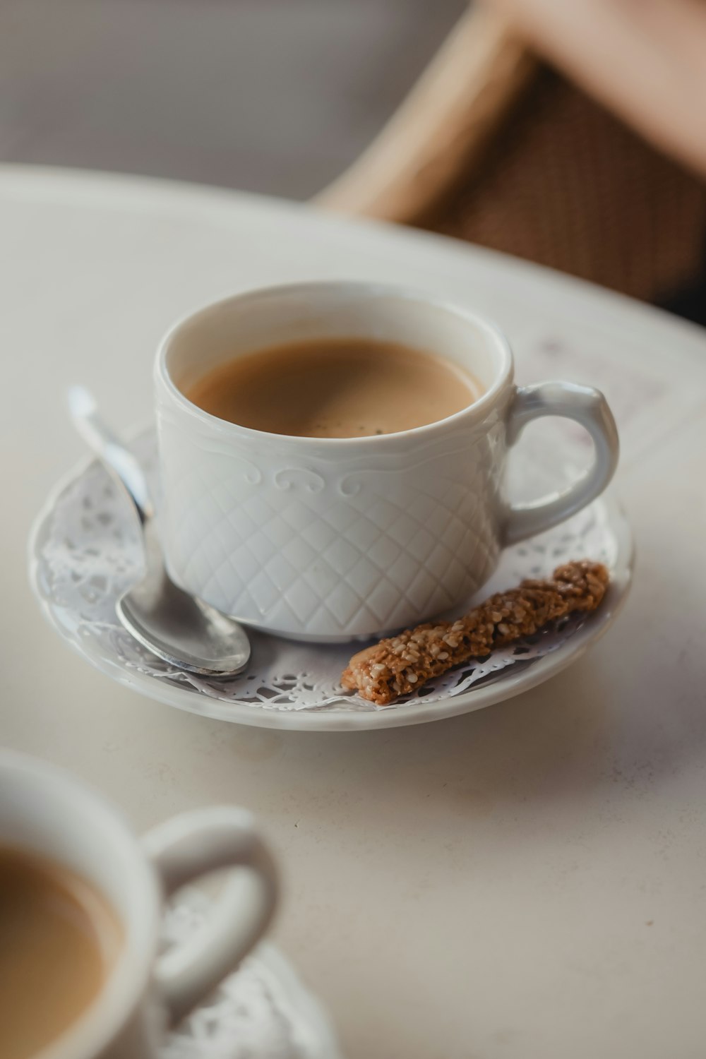 white ceramic mug on white ceramic saucer