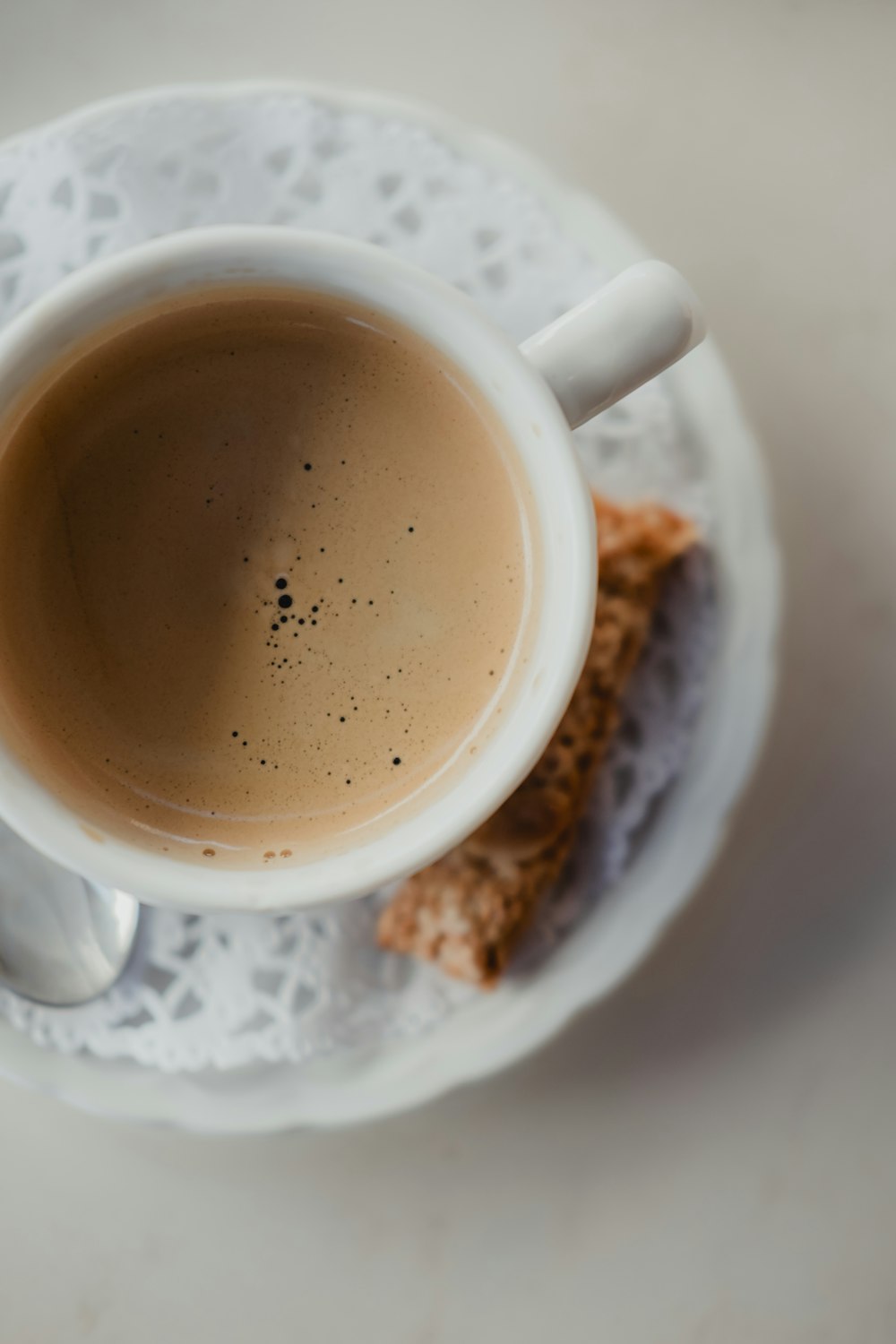 white ceramic mug with brown liquid