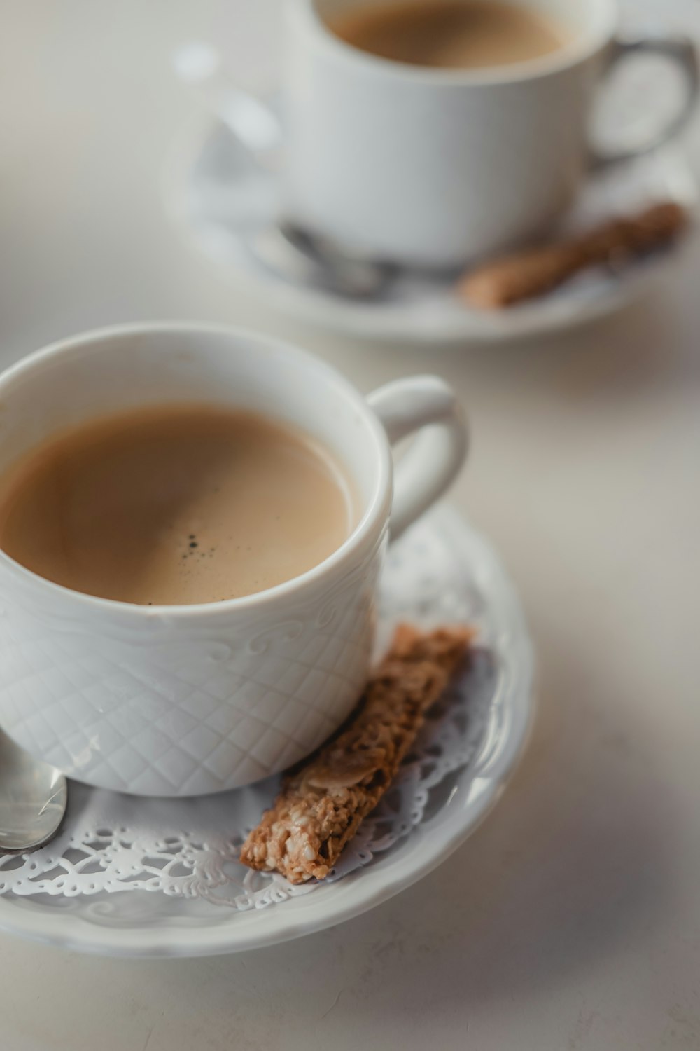 white ceramic mug with brown liquid