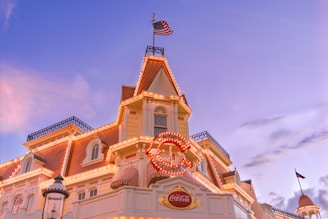 beige and white concrete building with flag of us a during daytime