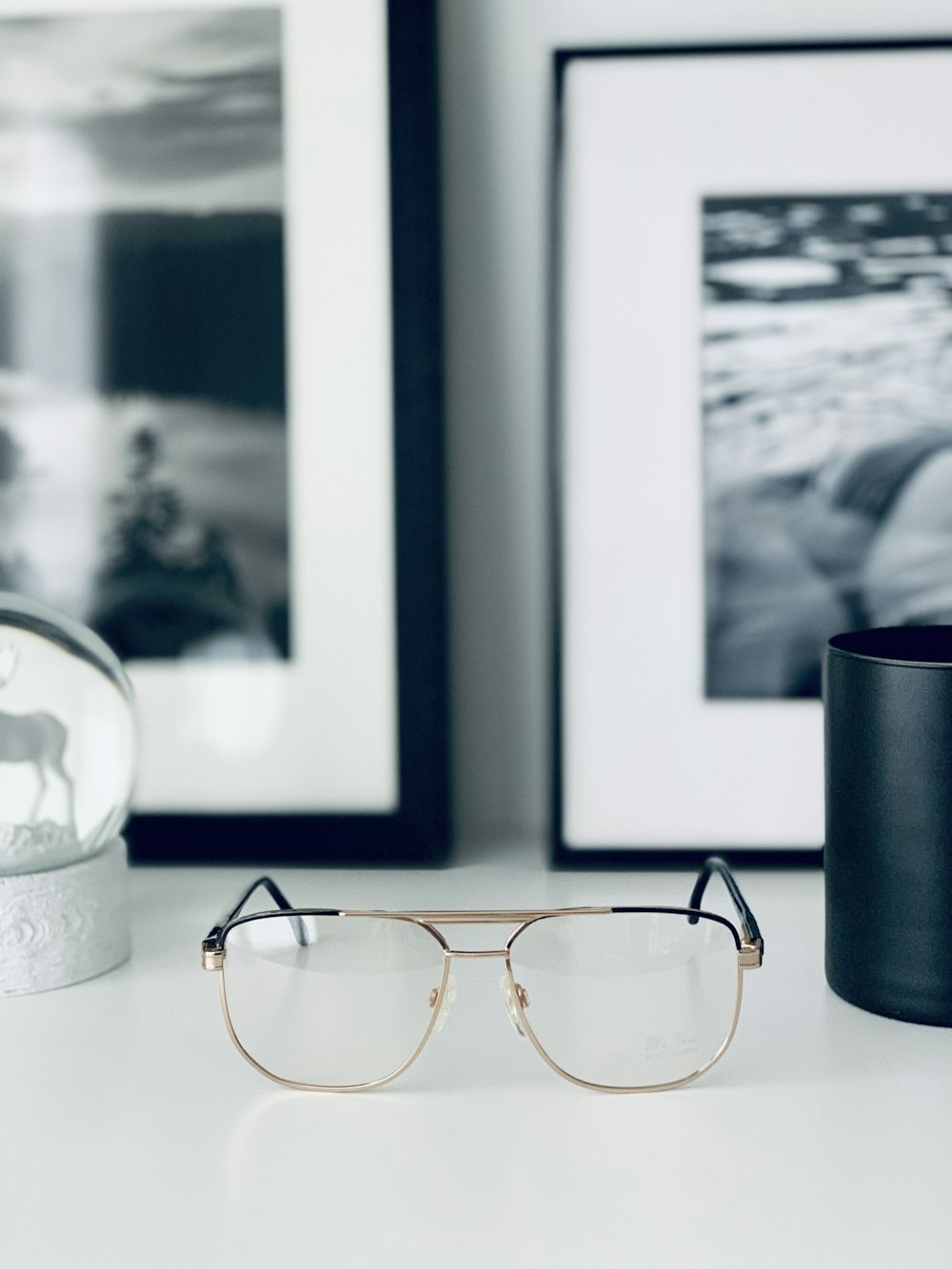 black framed eyeglasses on white table