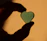 A serene close-up of hands gently holding a glowing heart-shaped crystal, resting on an open journal.