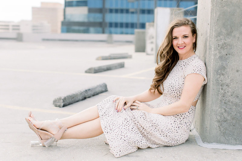 woman in polka dot dress sitting on concrete