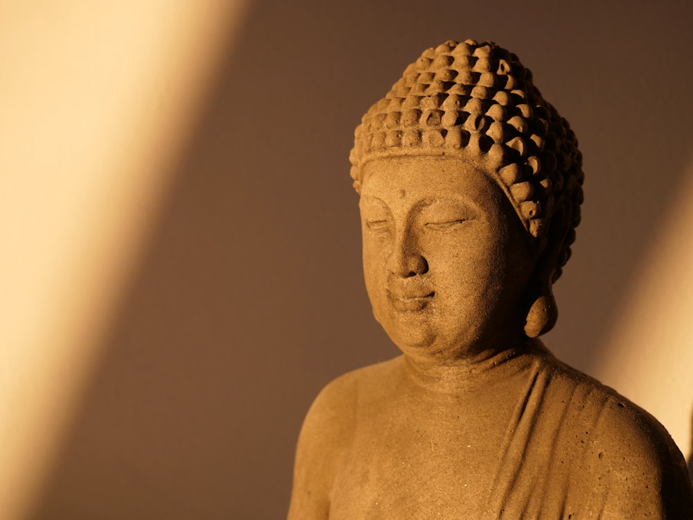 gold buddha statue in close up photography