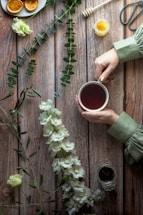 A cozy tea setup with a jar of honey and a sprinkle of spices on a wooden table.