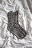 gray sock on white textile
