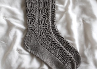 gray sock on white textile