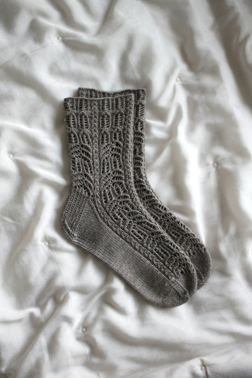 gray sock on white textile