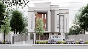 A modern, multi-story building with a minimalist design features large vertical windows and accent walls with wooden panels. The property is surrounded by a metal fence with a gate, and there are street lamps and tall trees along the perimeter. A car is parked inside the gated area, and the landscaped front garden is adorned with shrubs and plants.