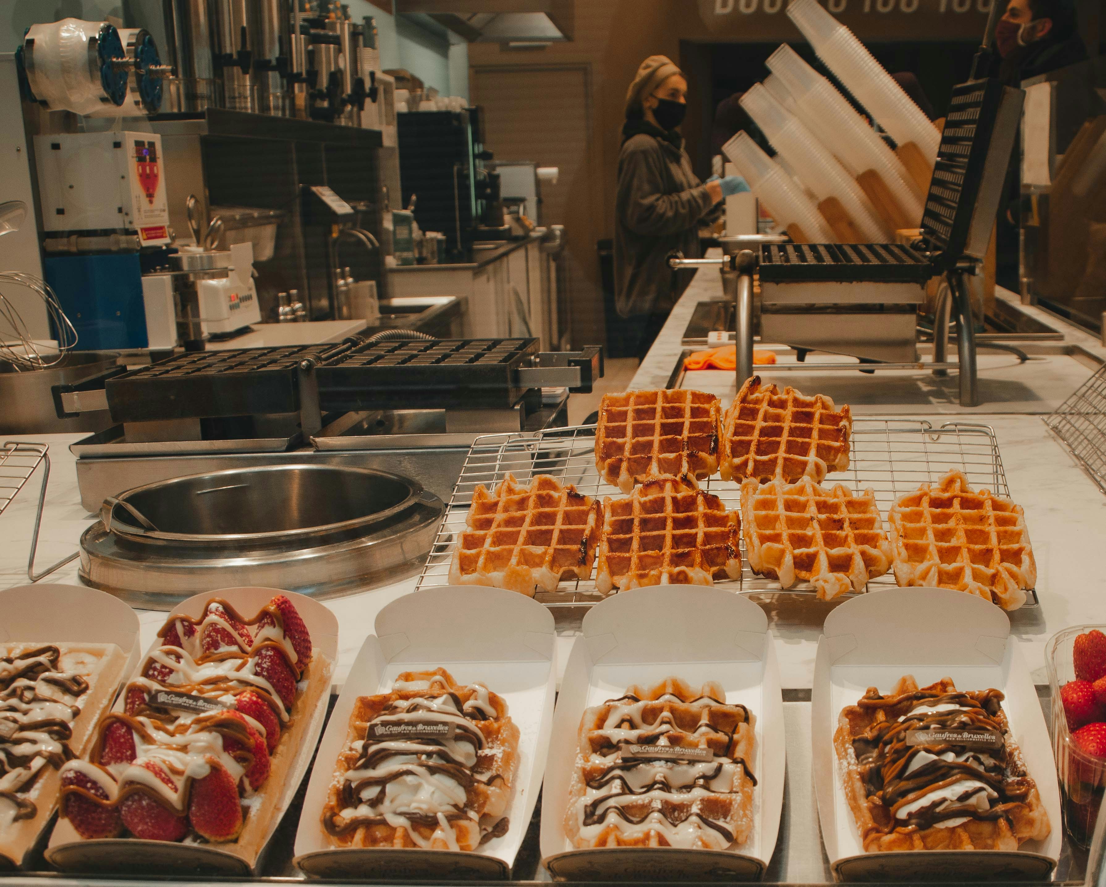 Rows of fresh waffles at a waffle counter