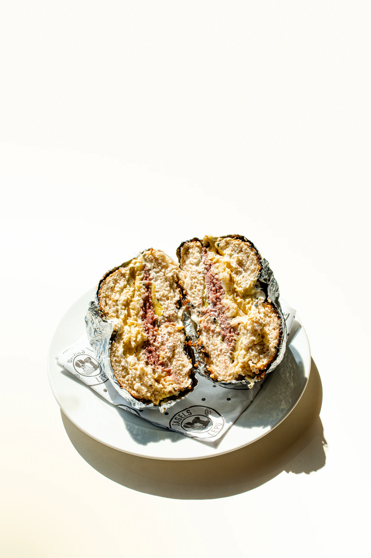 A pastrami-stuffed deli sandwich on rye, Reuben-style