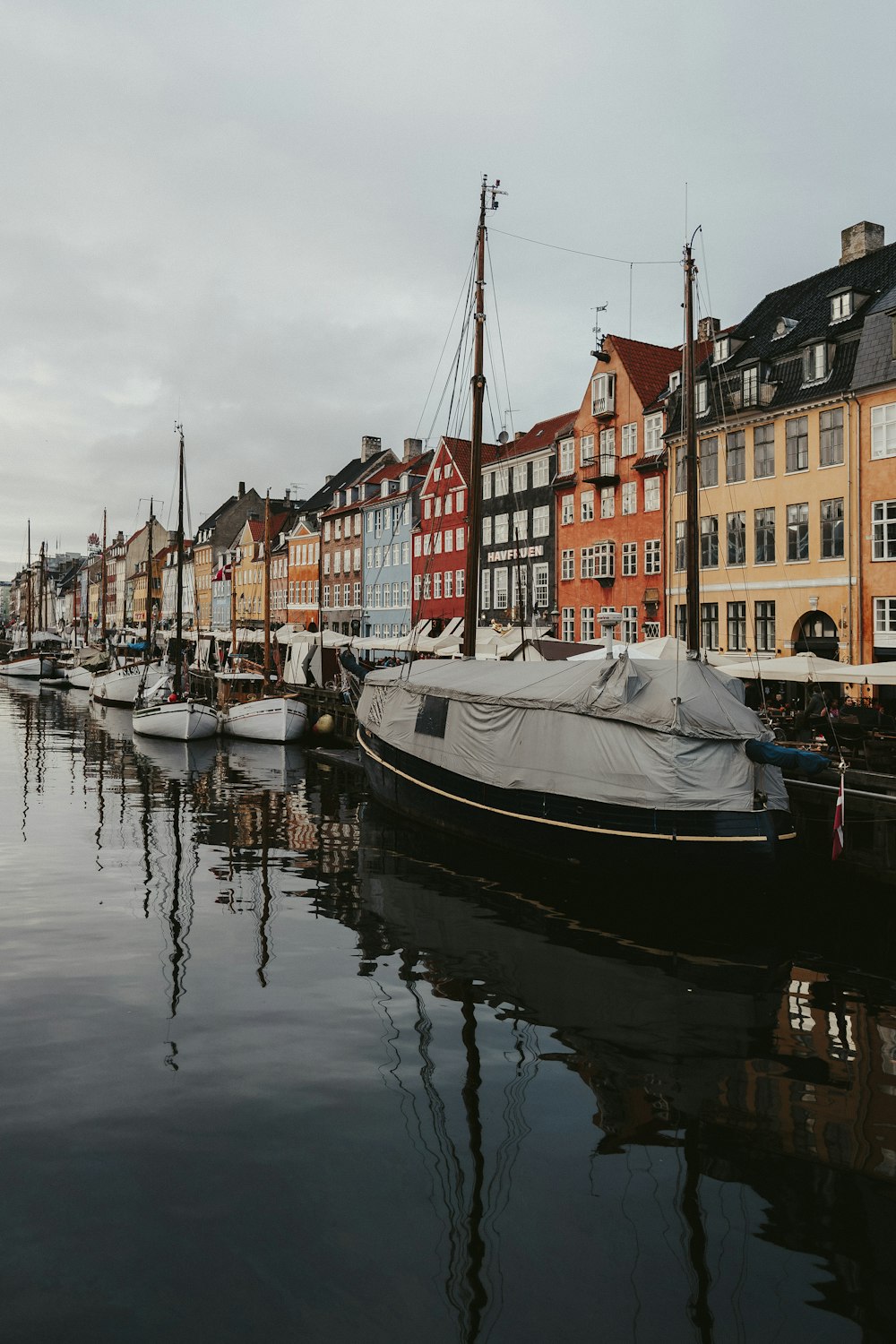 white boat on water near buildings during daytime