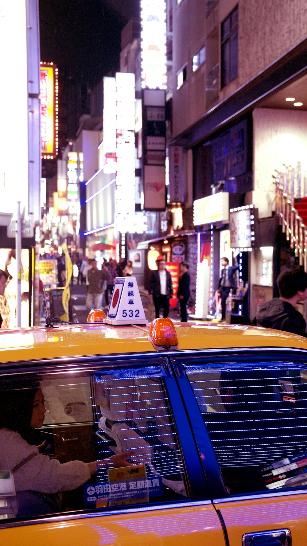 yellow taxi cab on street during daytime