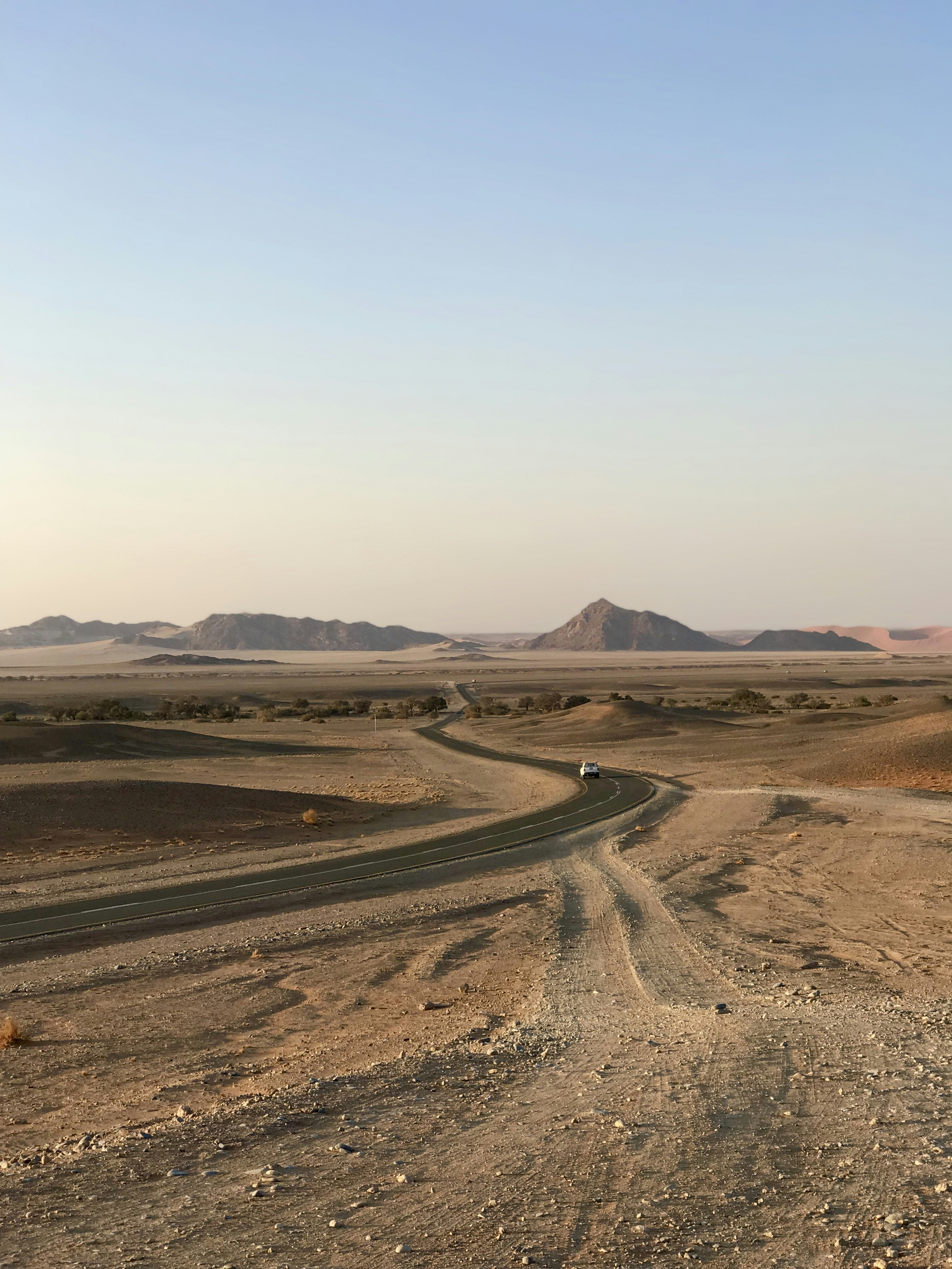 brown sand field near mountain during daytime