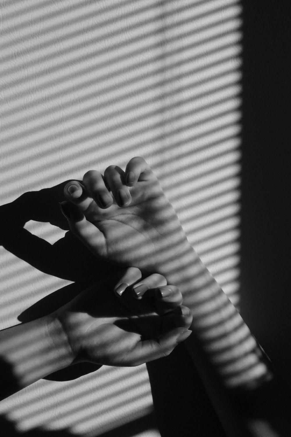 grayscale photo of persons hand forming heart