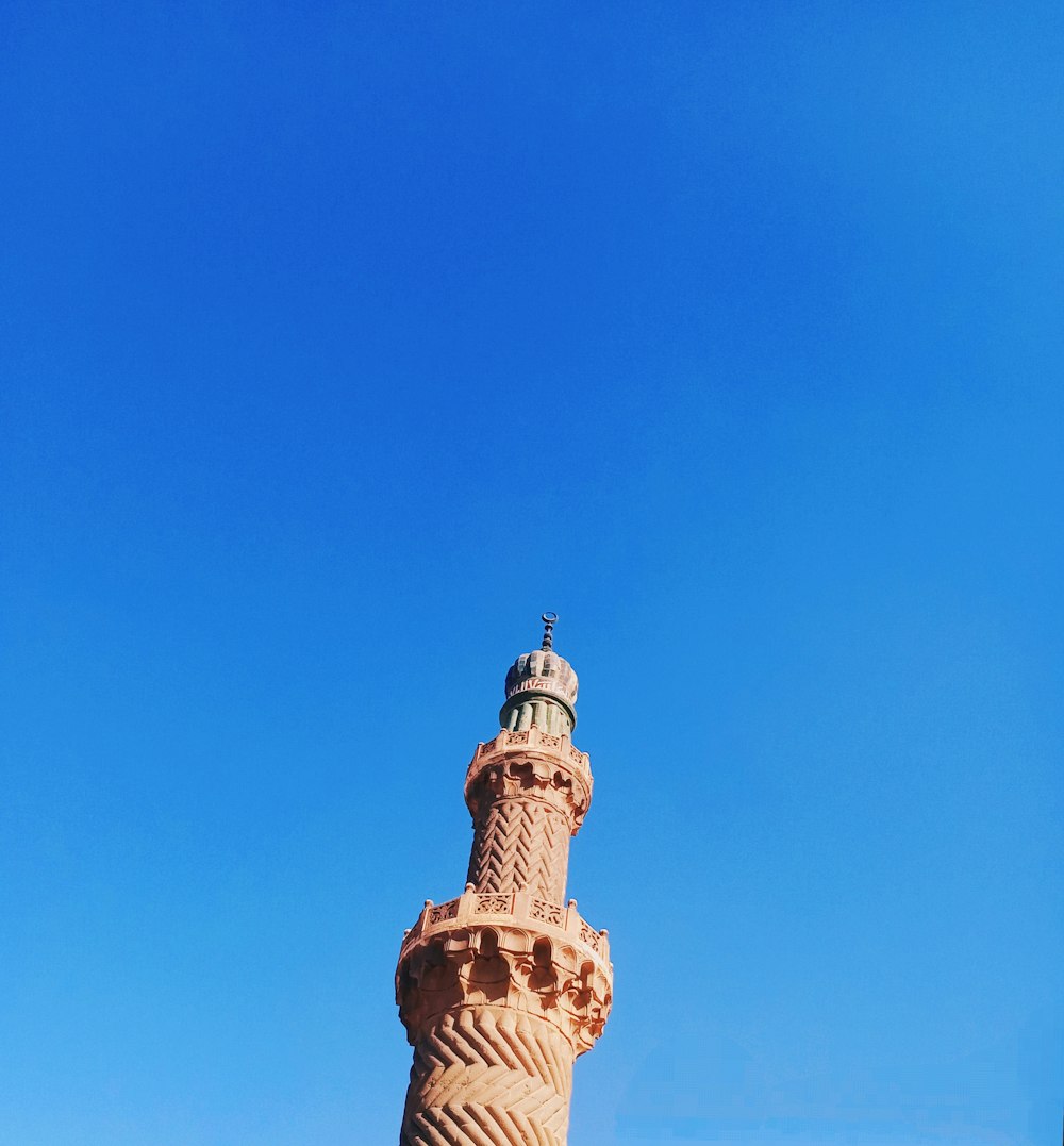 white concrete tower under blue sky during daytime