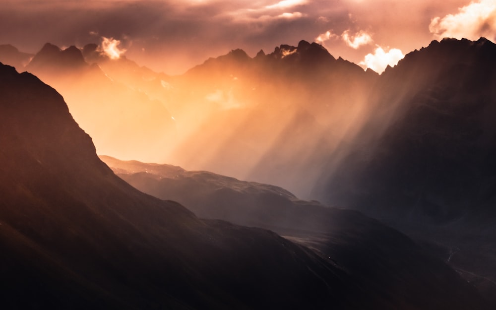 mountains under white clouds during daytime