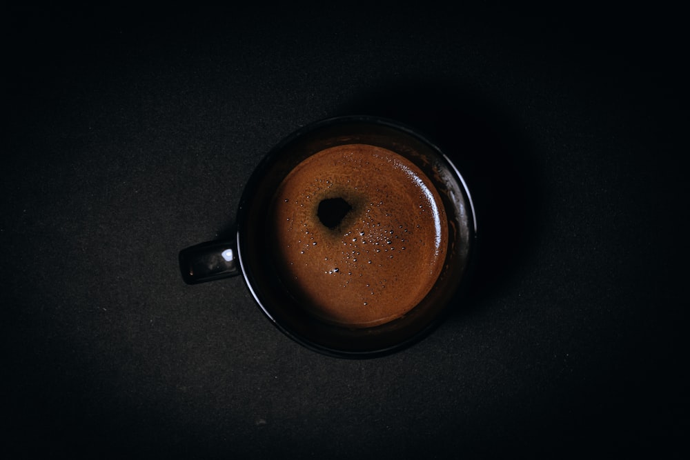 black ceramic mug with brown liquid