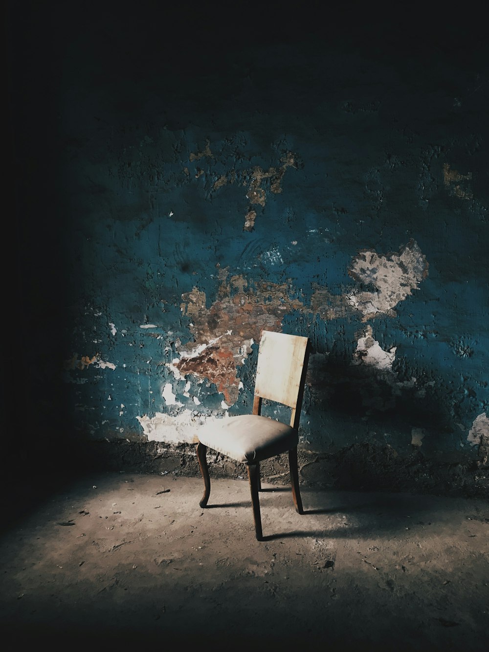 white and black chair on blue concrete floor