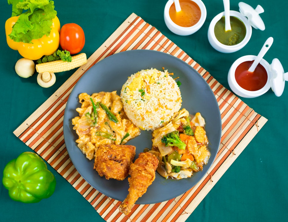 fried chicken with rice on blue ceramic plate