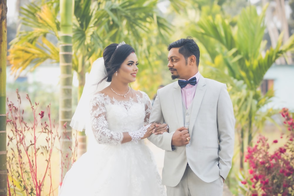 man in gray suit and woman in white wedding dress