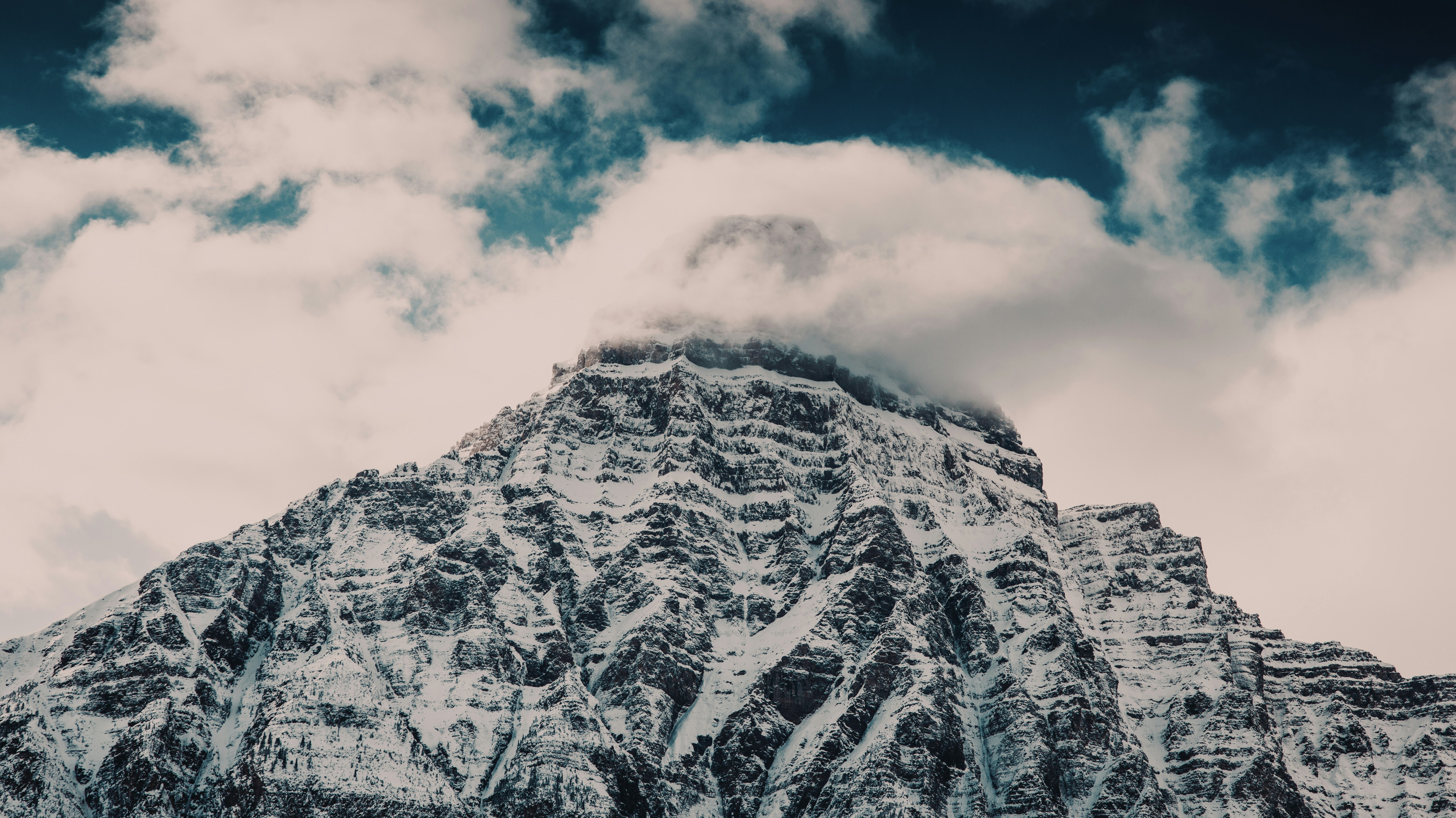 montaña cubierta de nieve bajo el cielo nublado durante el día