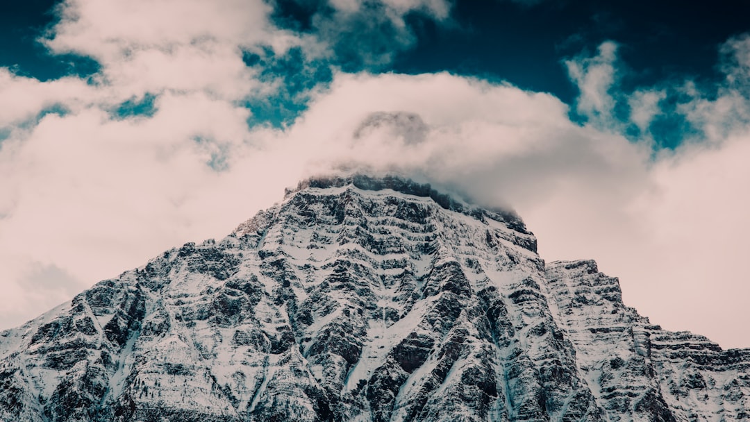 snow covered mountain under cloudy sky during daytime