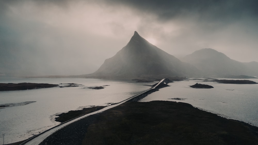 black mountain near body of water during daytime