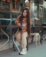 A person holding a wallet while sitting at a café.