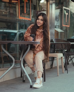 A person holding a wallet while sitting at a café.