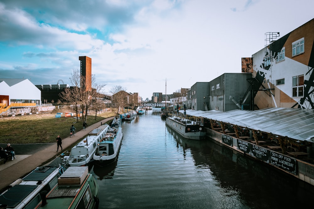 boat on dock near buildings during daytime