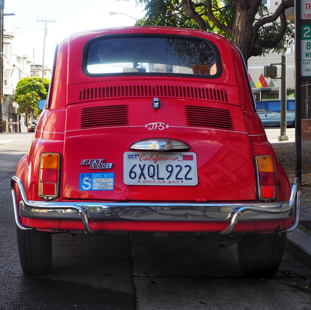 red car on the road during daytime