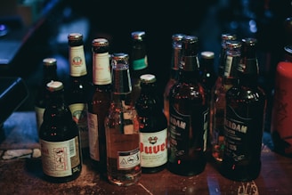 A selection of various beer bottles on a wooden table.