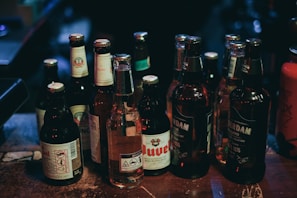 An elegant arrangement of craft beers in rustic glass bottles.